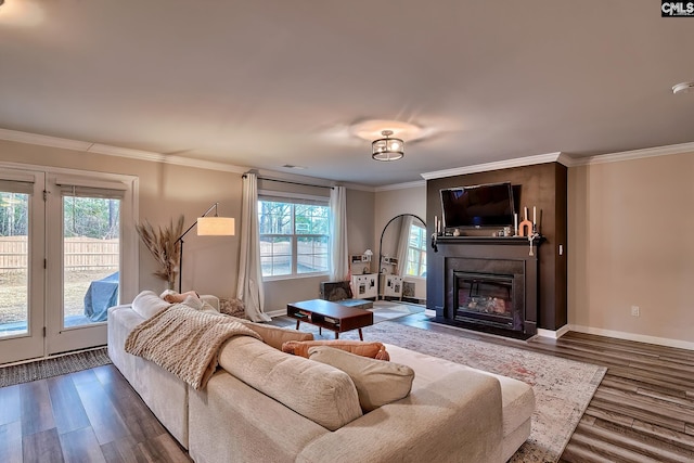 living room with crown molding, dark hardwood / wood-style floors, and a wealth of natural light