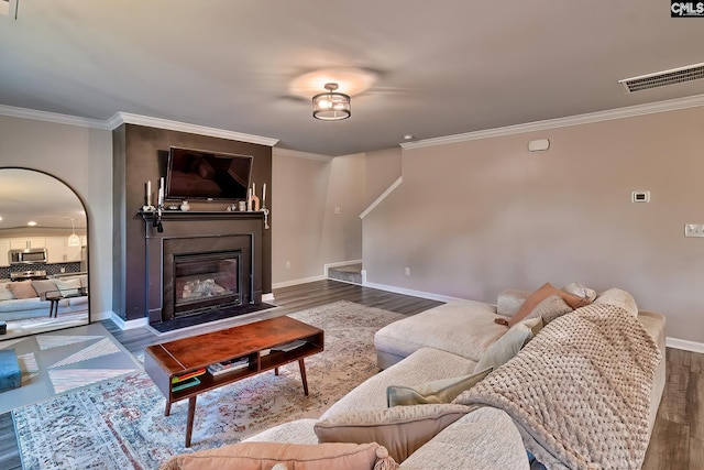 living room featuring hardwood / wood-style flooring and ornamental molding