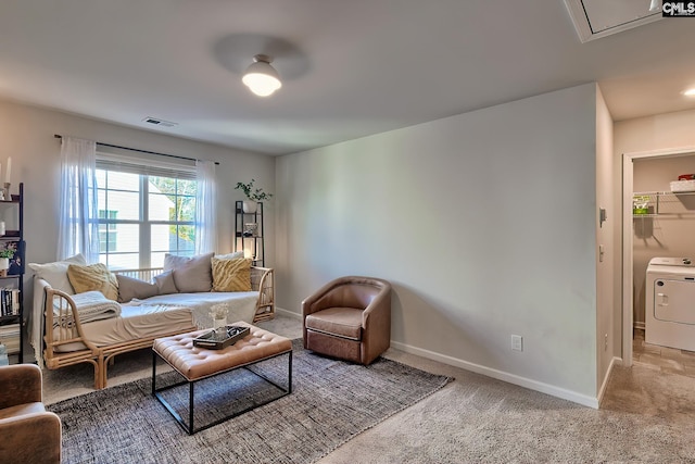 living room featuring washer / dryer and carpet