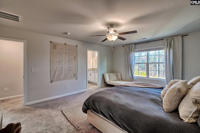 carpeted bedroom featuring ensuite bath and ceiling fan