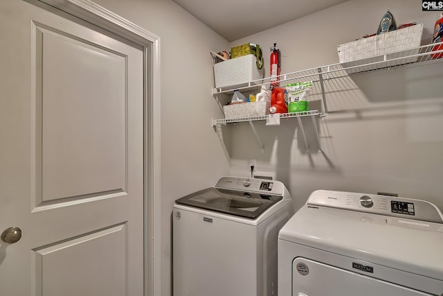 clothes washing area with independent washer and dryer