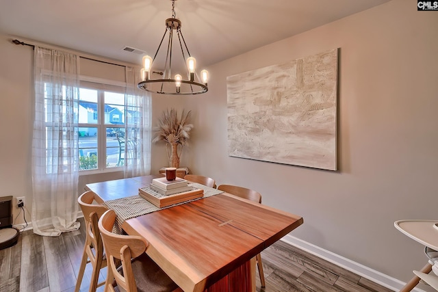 dining space with an inviting chandelier and dark hardwood / wood-style floors