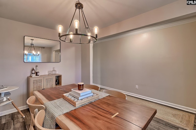 dining area featuring dark hardwood / wood-style flooring and a chandelier