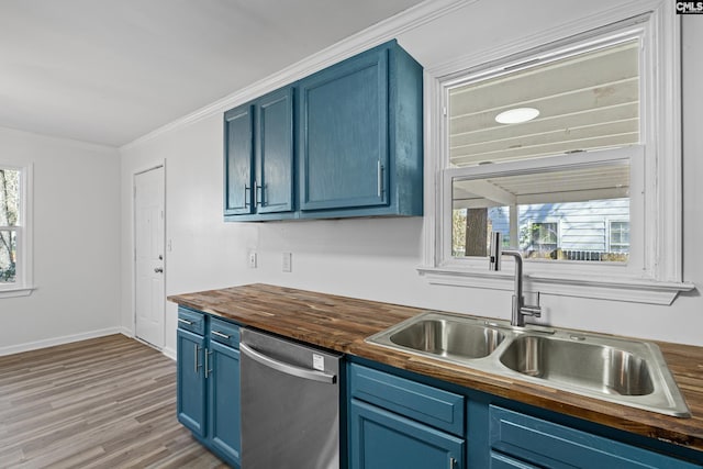 kitchen with wood counters, sink, blue cabinetry, and dishwasher