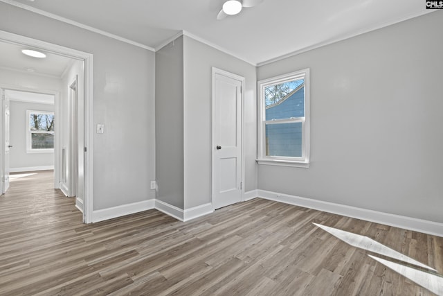 empty room featuring crown molding and light wood-type flooring