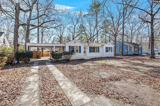 ranch-style home featuring a carport