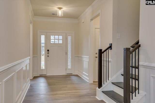 entryway featuring ornamental molding and hardwood / wood-style floors