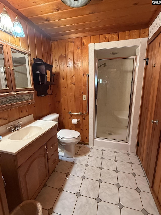 bathroom with wooden walls, vanity, toilet, a shower with door, and wooden ceiling