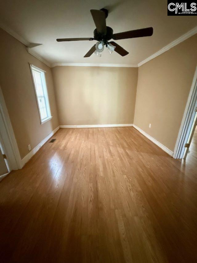 unfurnished room featuring light hardwood / wood-style flooring, ornamental molding, and ceiling fan