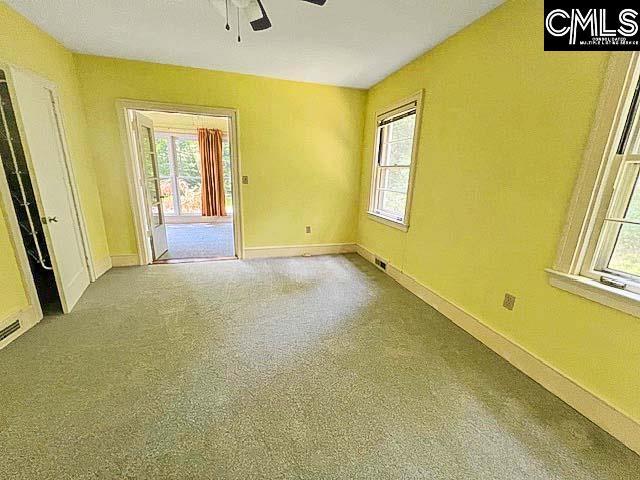 unfurnished room featuring carpet floors and ceiling fan