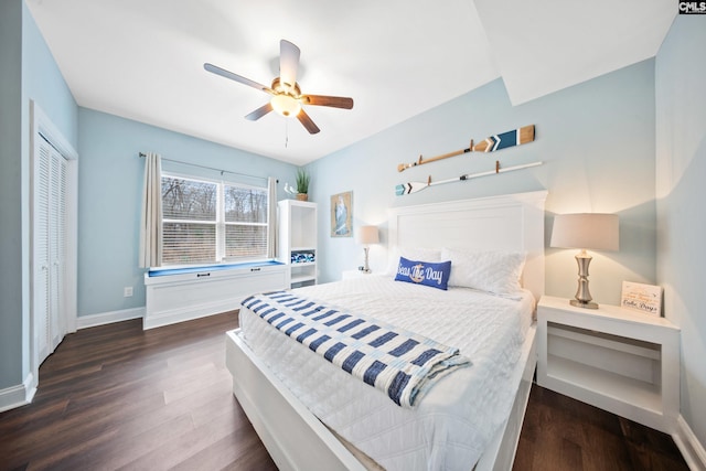 bedroom featuring ceiling fan, dark hardwood / wood-style flooring, and a closet