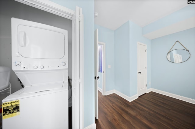 laundry area featuring dark wood-type flooring and stacked washer and clothes dryer