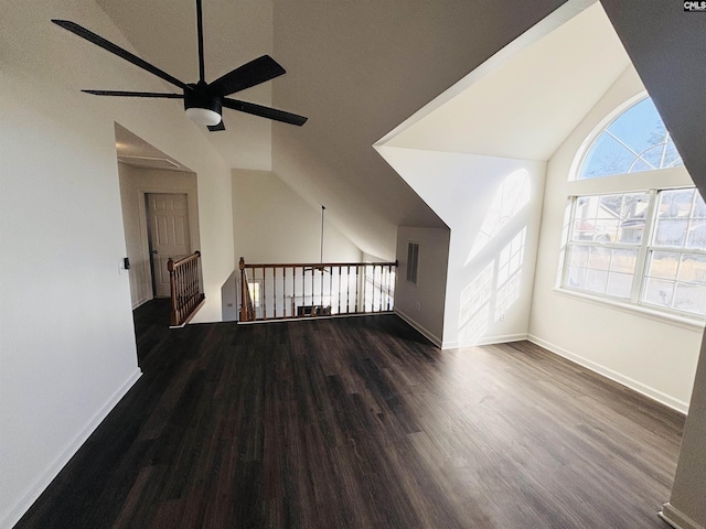 interior space featuring ceiling fan, lofted ceiling, and dark hardwood / wood-style floors