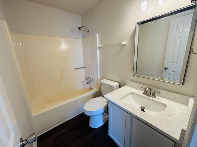 full bathroom with hardwood / wood-style flooring, shower / washtub combination, toilet, and vanity