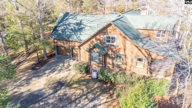 log cabin featuring a garage and central AC unit