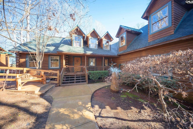 log cabin featuring a porch