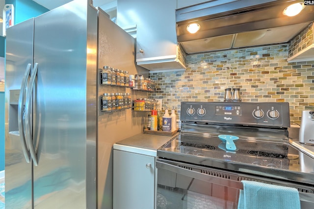 kitchen featuring black range with electric stovetop, backsplash, stainless steel refrigerator with ice dispenser, and extractor fan