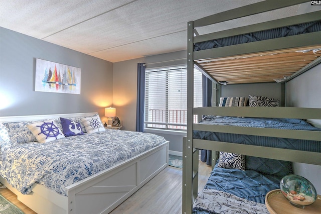 bedroom featuring wood-type flooring and a textured ceiling