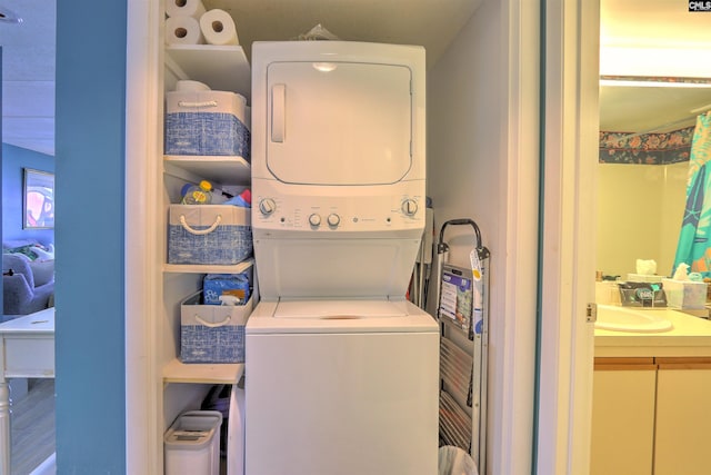 washroom featuring stacked washing maching and dryer