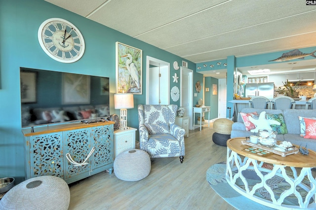 living room with hardwood / wood-style floors and a textured ceiling