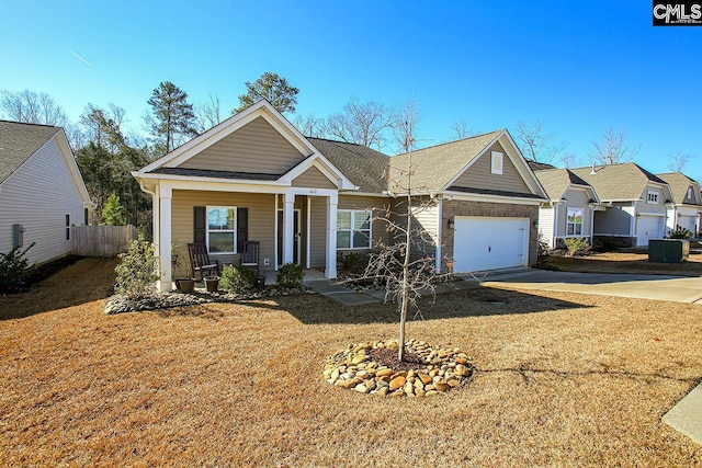 single story home featuring a garage and a porch