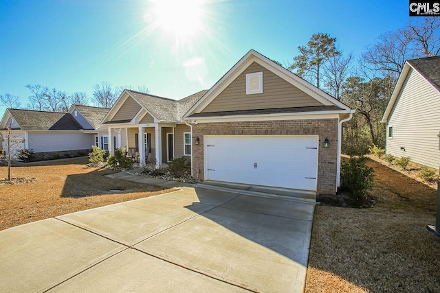 craftsman inspired home with a porch and a garage