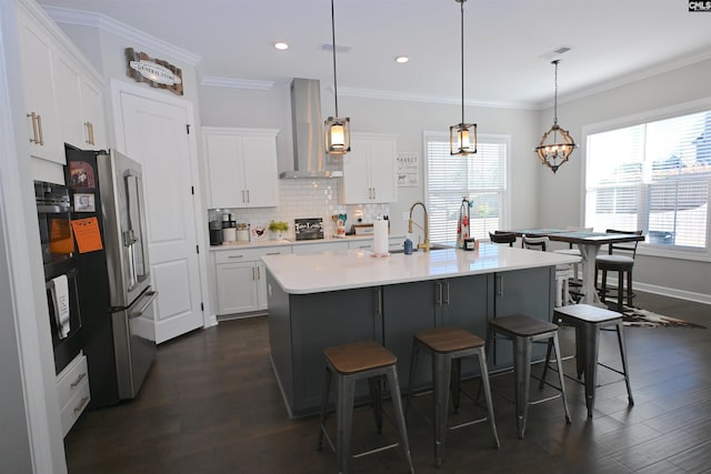 kitchen featuring white cabinetry, hanging light fixtures, ventilation hood, and high end refrigerator