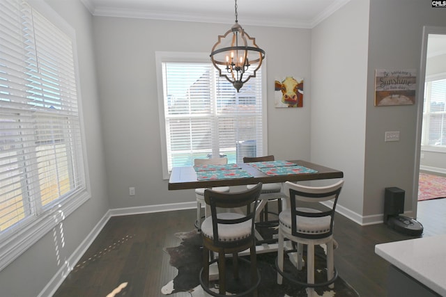 dining space with an inviting chandelier, crown molding, and dark hardwood / wood-style floors