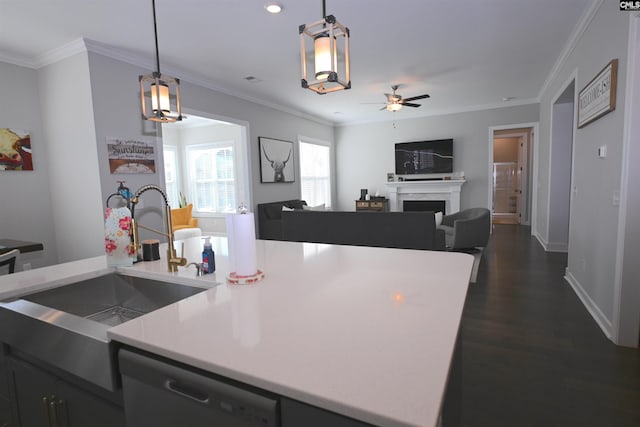 kitchen with crown molding, decorative light fixtures, black dishwasher, and sink