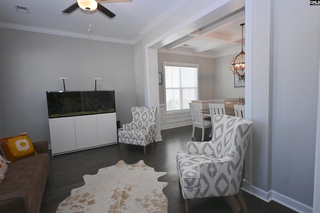 sitting room with ceiling fan with notable chandelier, dark hardwood / wood-style flooring, ornamental molding, coffered ceiling, and beam ceiling