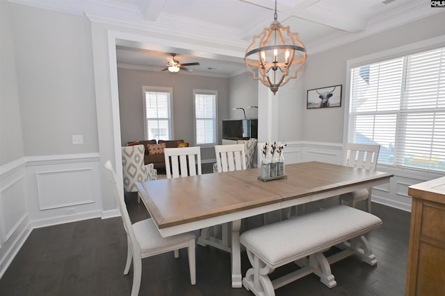 dining area with dark wood-type flooring, ornamental molding, and a healthy amount of sunlight