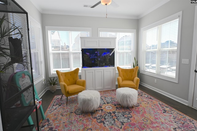 sitting room with crown molding, plenty of natural light, and dark hardwood / wood-style flooring