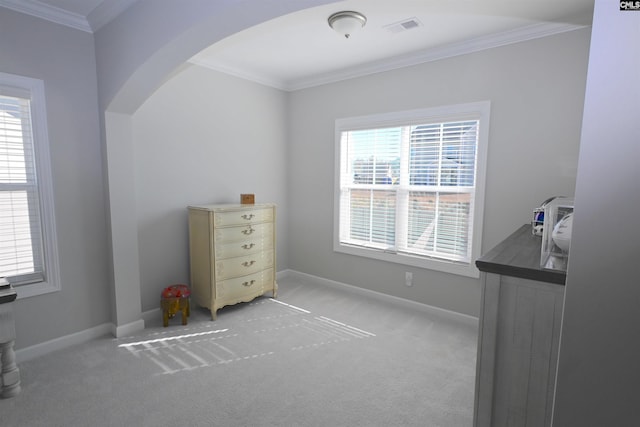 bedroom featuring ornamental molding and light colored carpet