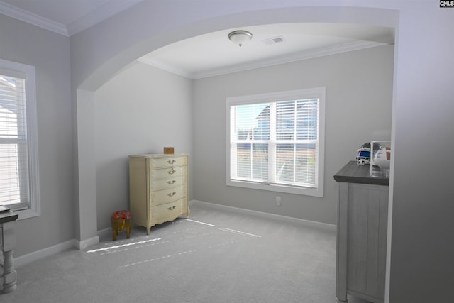 bedroom featuring crown molding and light carpet