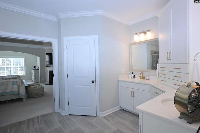 bathroom with vanity, ornamental molding, and walk in shower