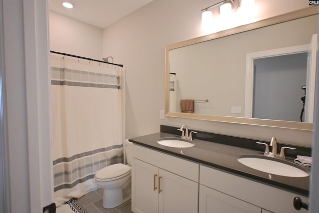 bathroom featuring tile patterned flooring, vanity, a shower with curtain, and toilet