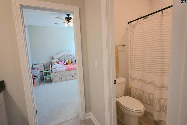 bathroom with ceiling fan and toilet