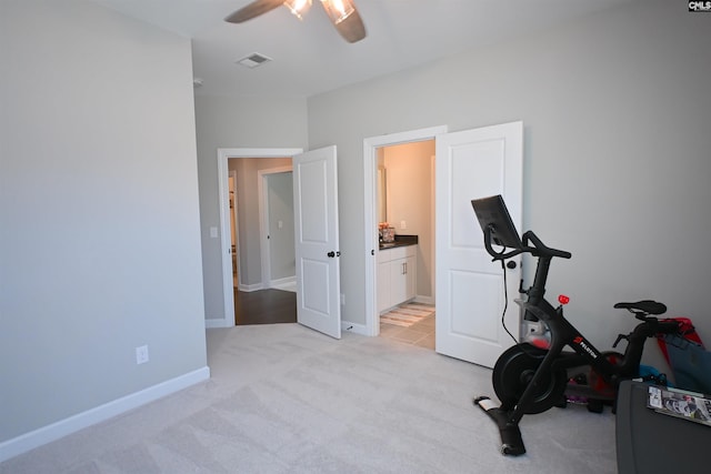 workout room with light colored carpet and ceiling fan