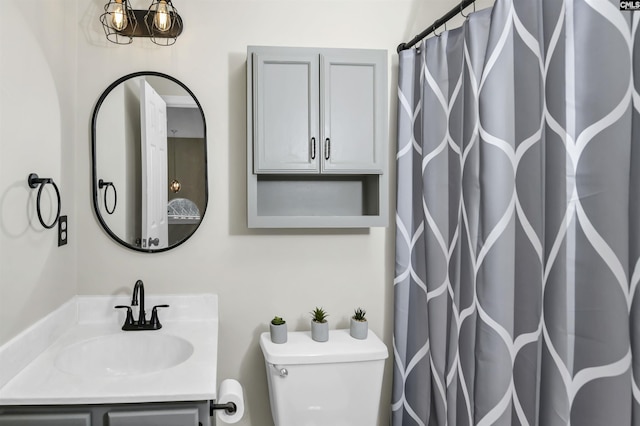 bathroom featuring walk in shower, vanity, and toilet