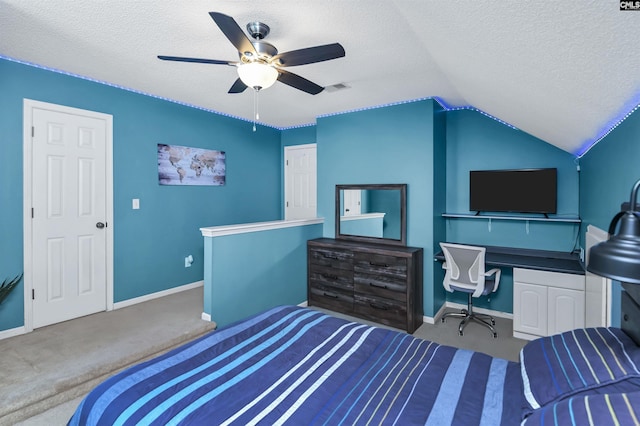 carpeted bedroom with vaulted ceiling, ceiling fan, and a textured ceiling