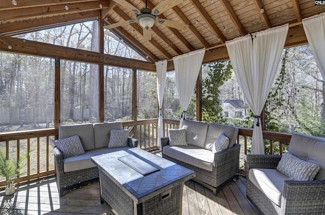 sunroom featuring lofted ceiling with beams, a wealth of natural light, and ceiling fan