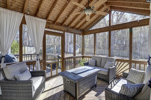 sunroom / solarium featuring lofted ceiling with beams, a wealth of natural light, wooden ceiling, and ceiling fan