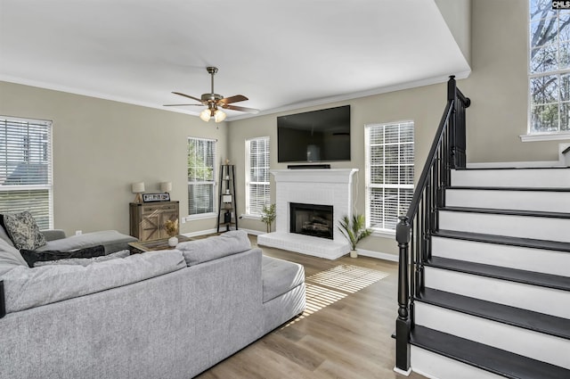 living room featuring hardwood / wood-style floors, crown molding, and a healthy amount of sunlight