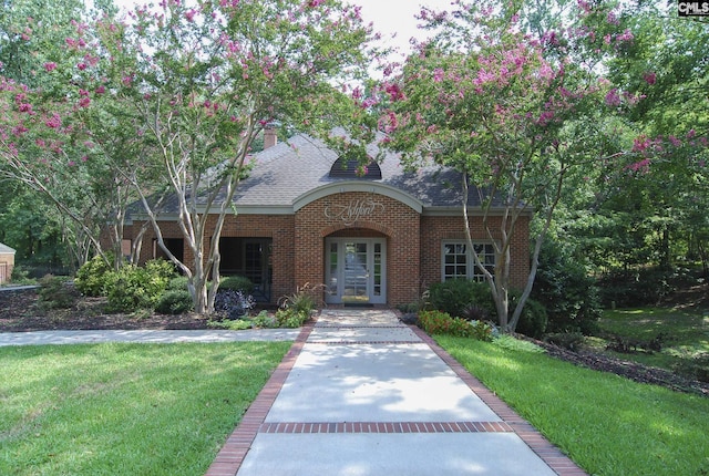 view of front of home featuring french doors and a front lawn