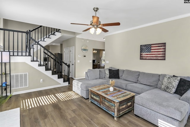 living room featuring ornamental molding, hardwood / wood-style floors, and ceiling fan