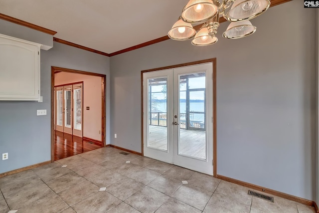 entryway featuring french doors, crown molding, light tile patterned flooring, and a chandelier