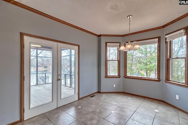 doorway with a chandelier, light tile patterned floors, crown molding, a textured ceiling, and french doors