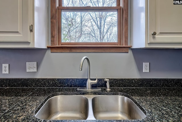 interior details with white cabinetry and sink