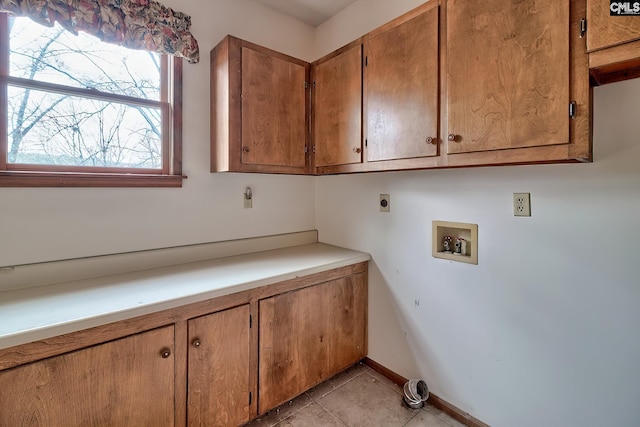 clothes washing area with cabinets, light tile patterned floors, hookup for a washing machine, and electric dryer hookup