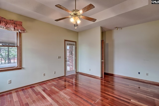 empty room with ceiling fan and hardwood / wood-style floors